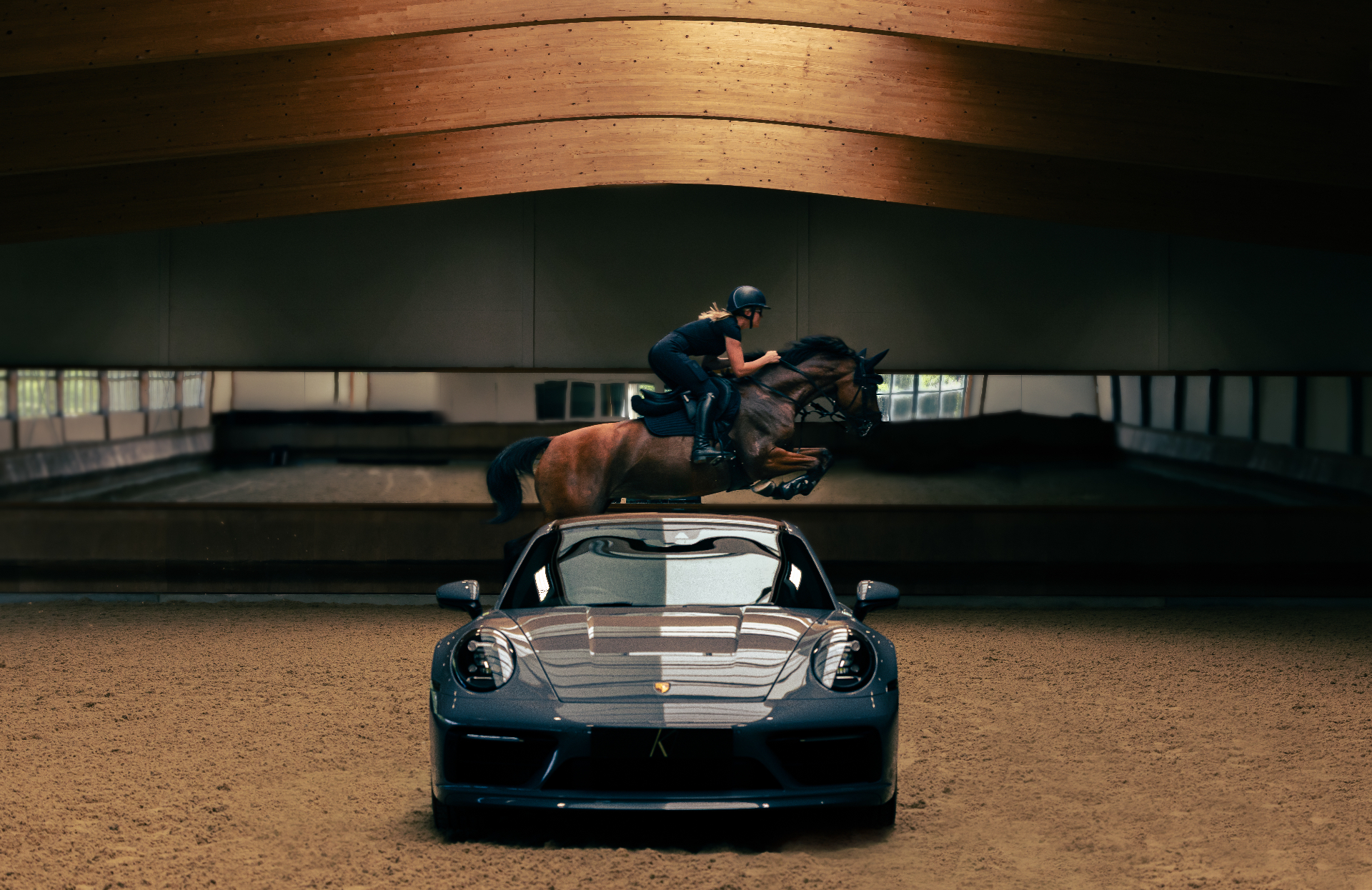Home Farm Equestrian indoor arena bathed in a single shaft of light